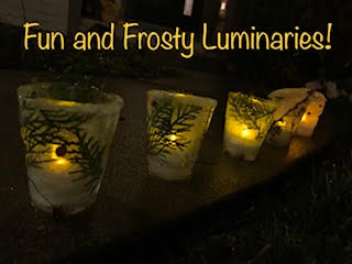 A picture of ice luminaries decorated with branches and berries.