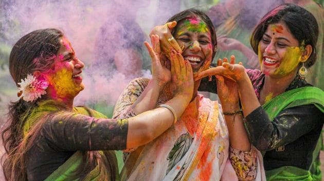 friends applying holi colors on each other